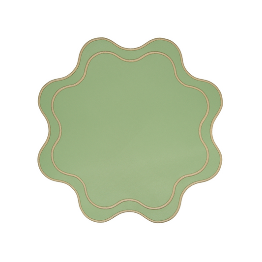 A round, light green faux leather placemat with a textured surface and decorative stitching around the edge.