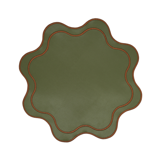 A round dark green faux leather placemat with a scalloped edge and red stitching detail.