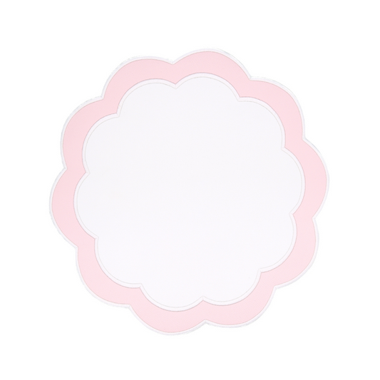 A round pink faux leather placemat with embroidered details on a white background.