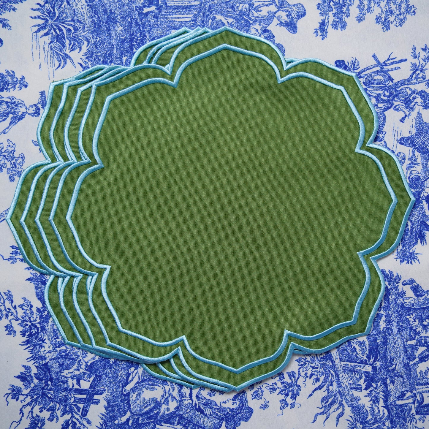Green placemat with floral patterned fabric background