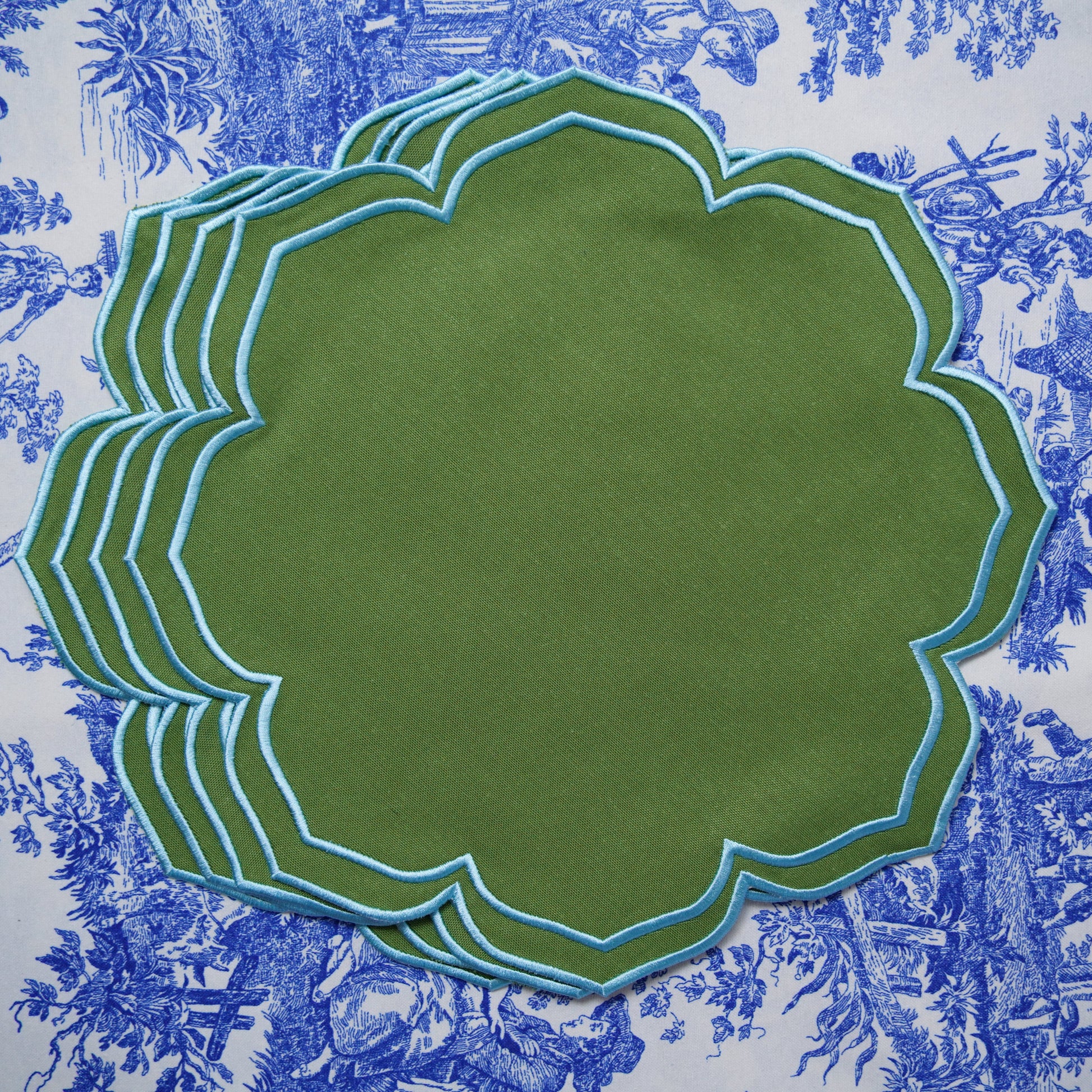 Green placemat with floral patterned fabric background