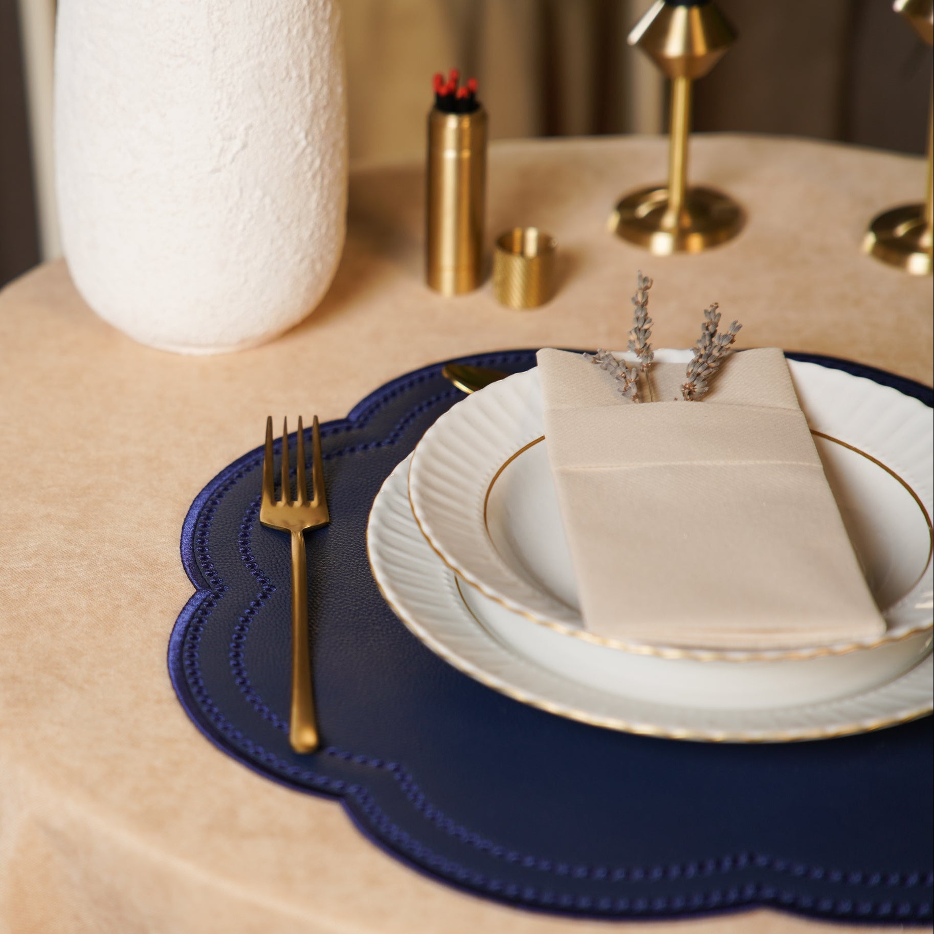 Dining table setting with plates, napkin, and fork on a blue placemat.