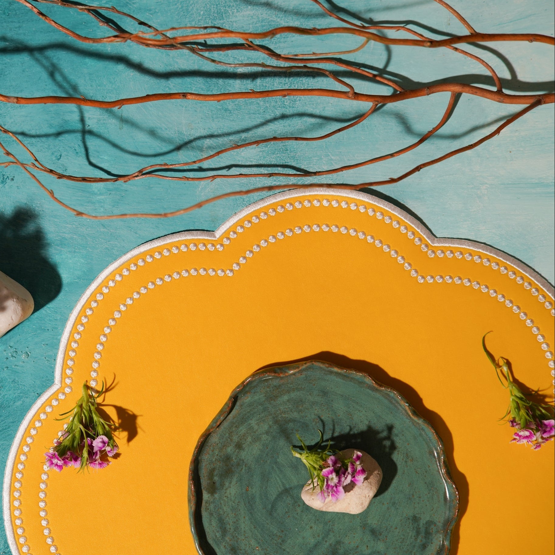 Decorative yellow plate with a green center on a blue background