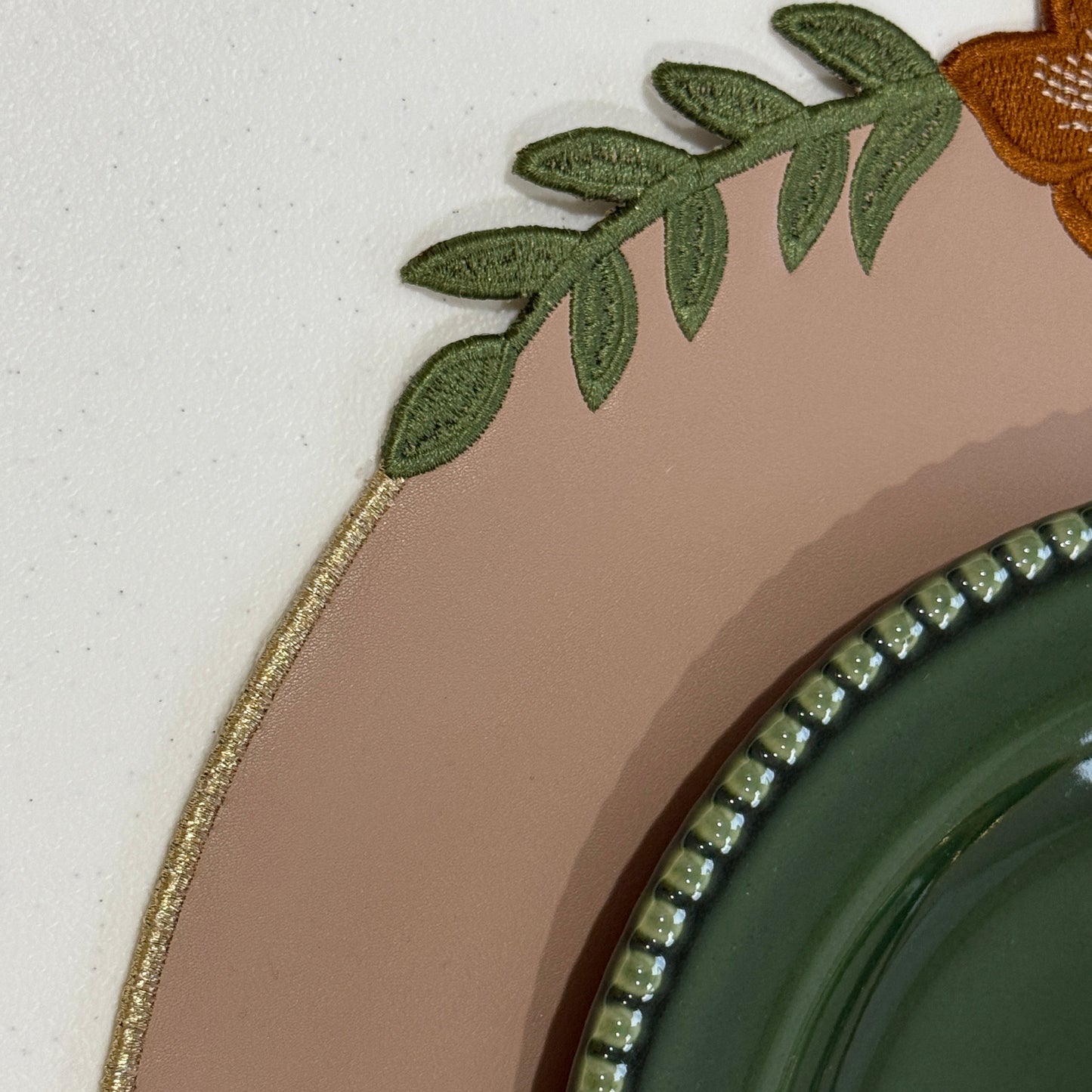 Decorative plate with floral design and green rim on a white background