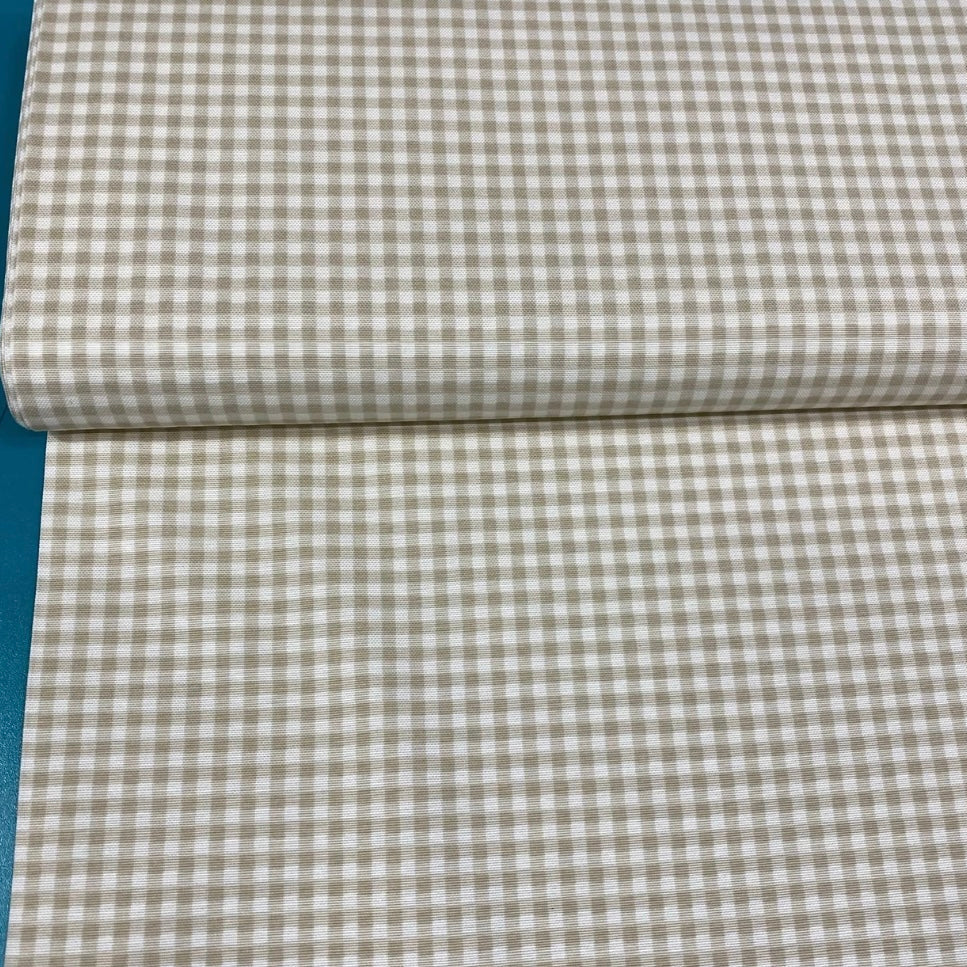 A rolled-up beige and white checkered tablecloth.
