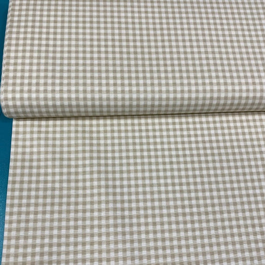 A rolled-up beige and white checkered tablecloth.