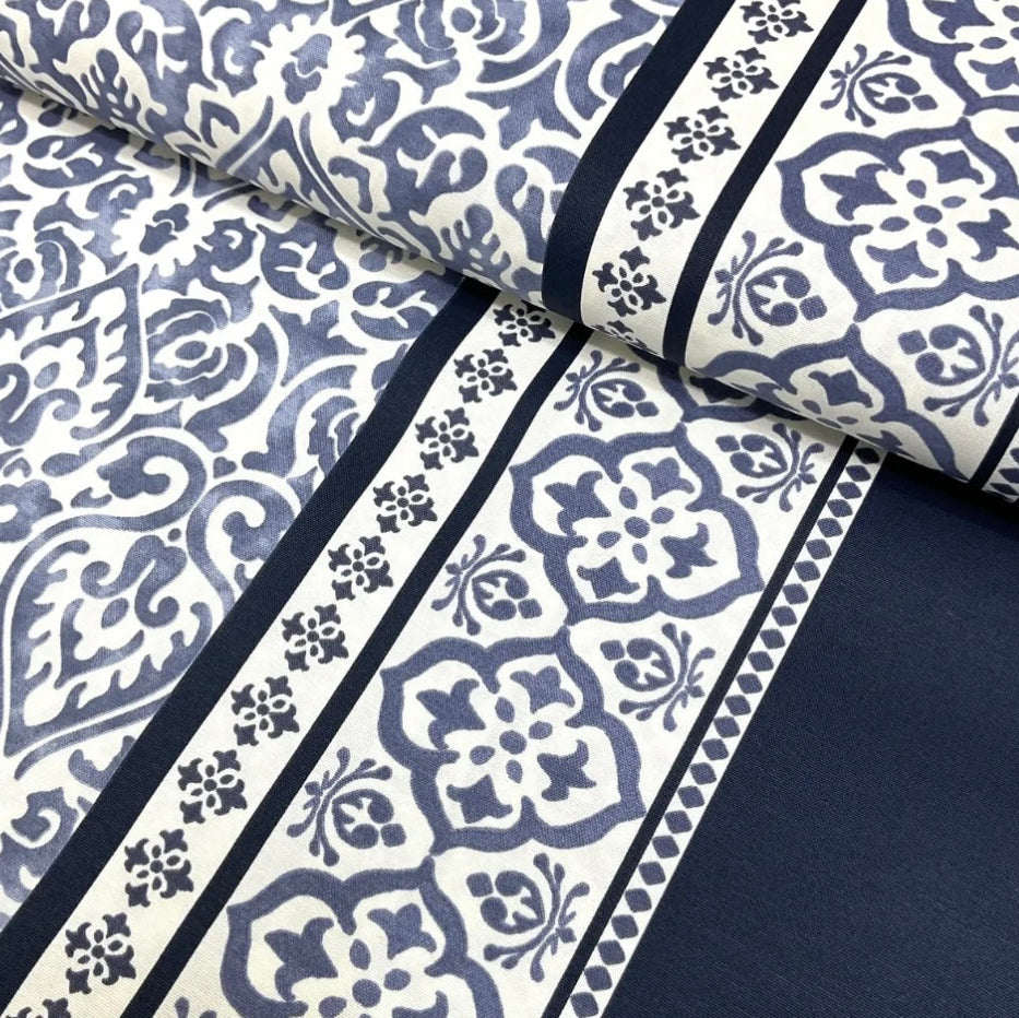 Close-up view of a black and white geometric patterned tablecloth.