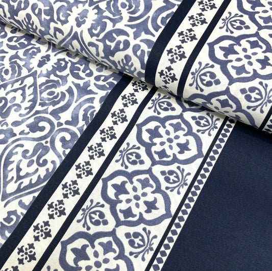 Close-up view of a black and white geometric patterned tablecloth.