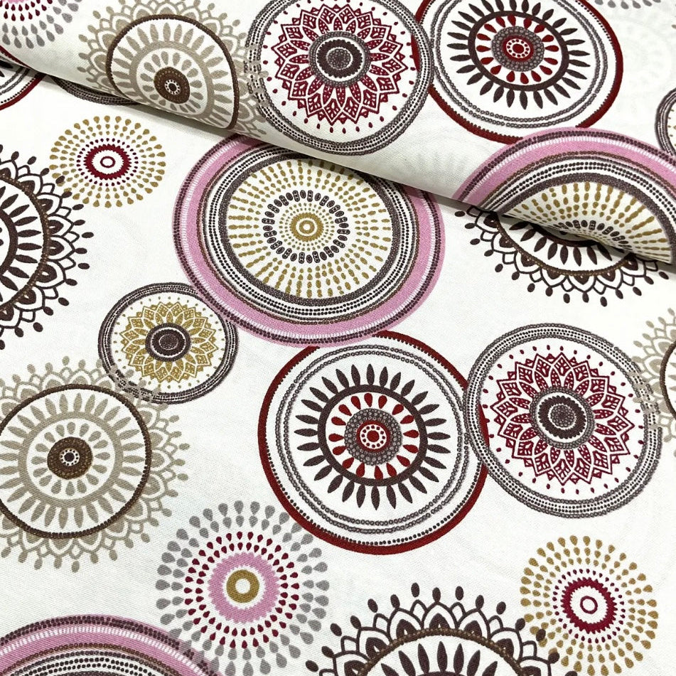 A rectangular tablecloth with a floral and geometric pattern in pink, white, and beige colors.