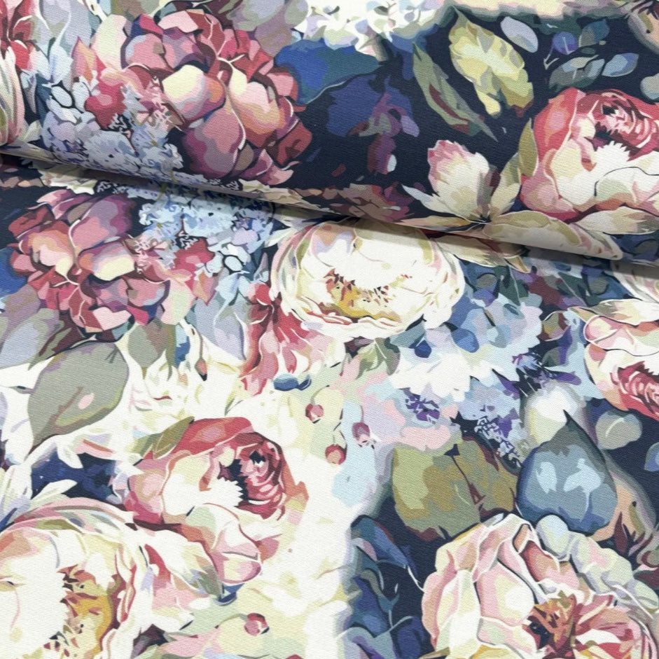 Close-up view of a rectangle tablecloth with a floral pattern in shades of blue, displaying the texture and color details.