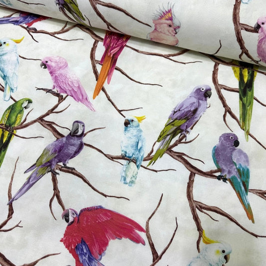A rectangular tablecloth with a floral pattern featuring colorful birds perched on branches, displayed in a rolled-up fashion.
