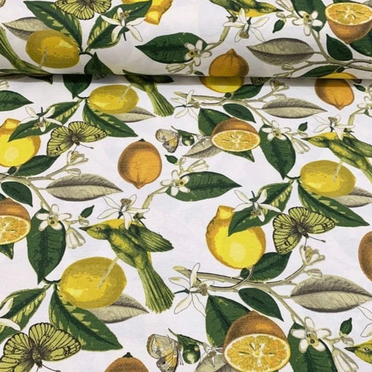 A rectangular tablecloth with a floral and lemon pattern in yellow, green, and white colors.