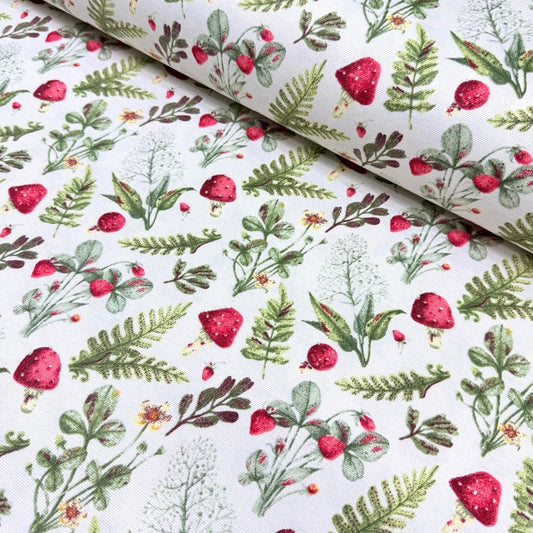 A rectangular tablecloth with a floral pattern featuring red mushrooms and green leaves on a white background.