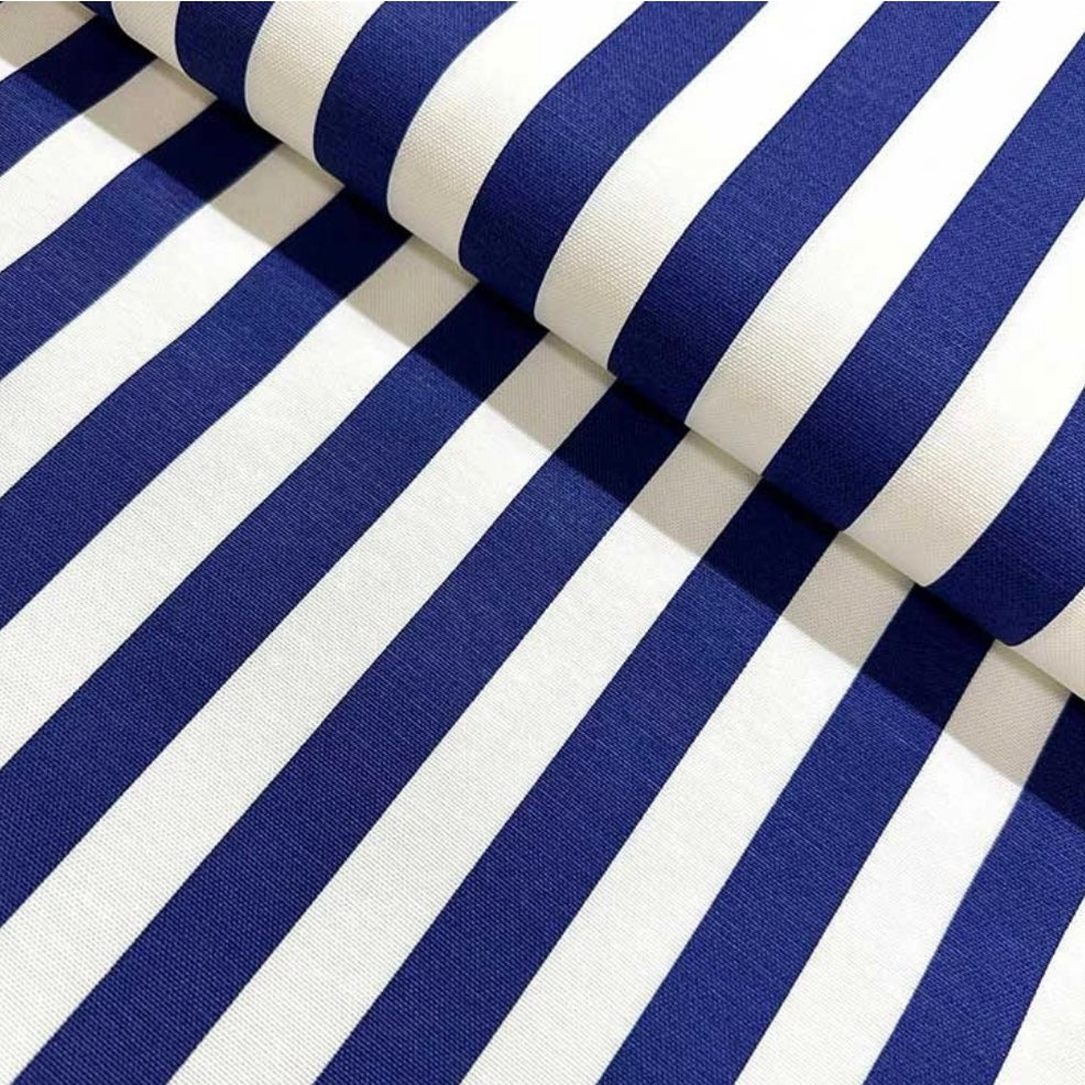 Close-up view of a folded blue and white striped tablecloth.
