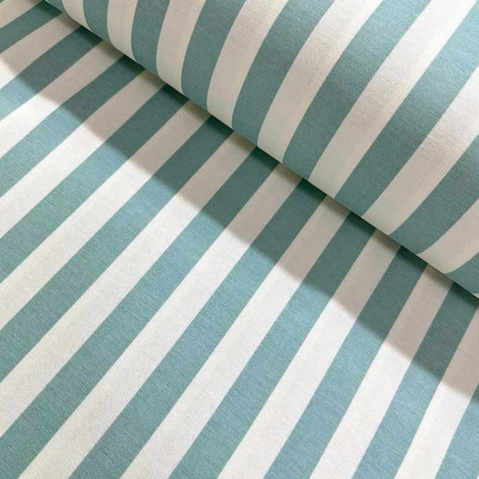 Close-up of a folded striped tablecloth in black and white, showcasing the fabric's texture and the stripe pattern.