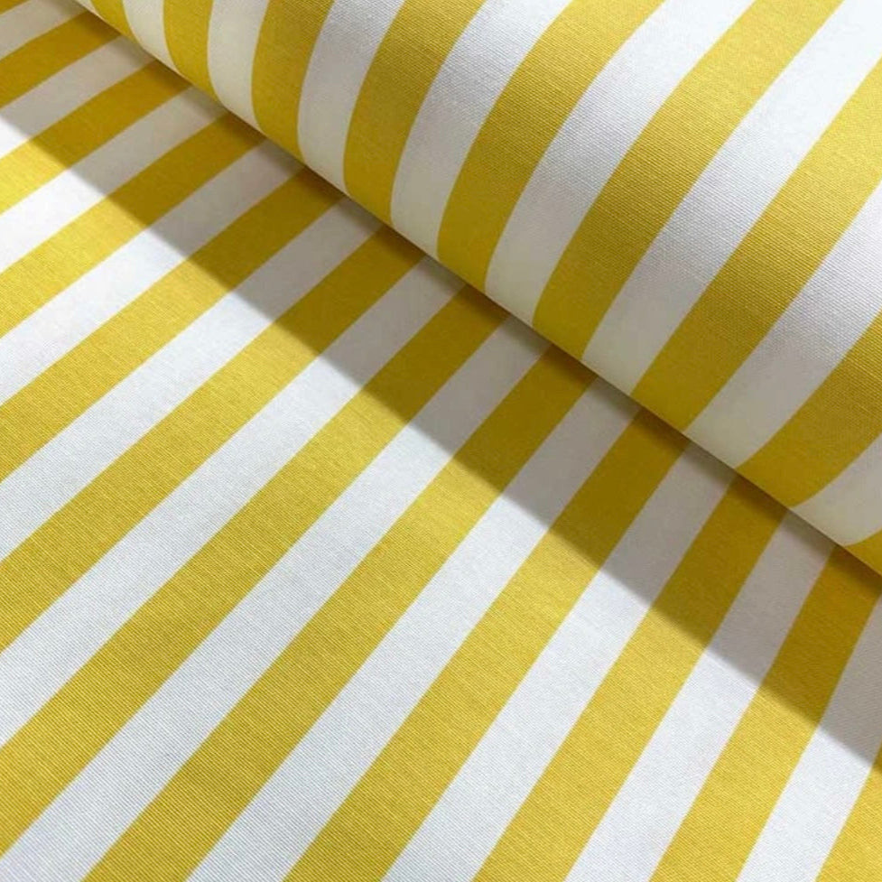 Close-up view of a yellow and white striped rectangular tablecloth.