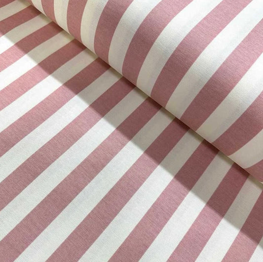 Close-up view of a pink and white striped tablecloth with a focus on the fabric's texture and fold.