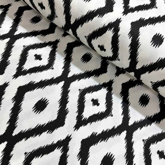 Close-up view of a black and white geometric patterned tablecloth.