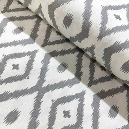A folded gray and white geometric patterned tablecloth.