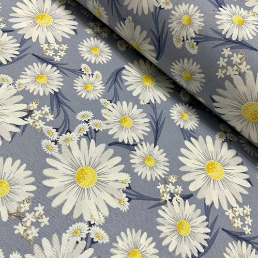 A rectangular tablecloth with a floral pattern, featuring yellow daisies on a gray background.
