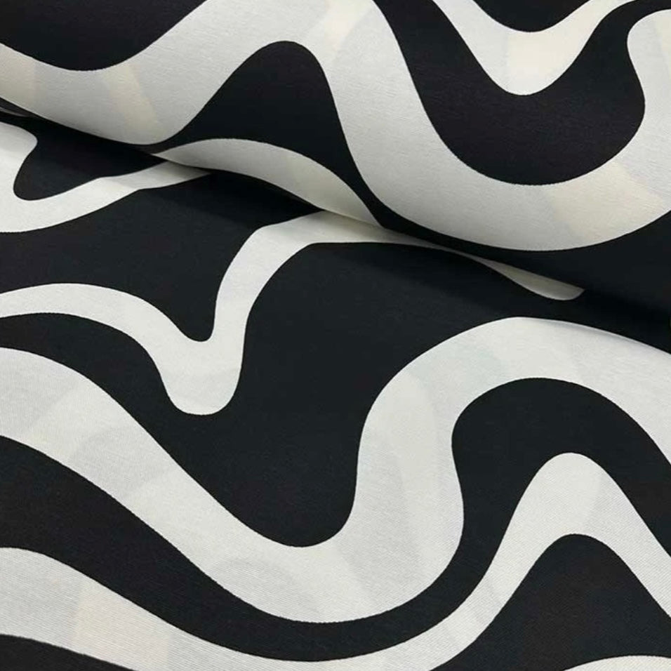 Close-up view of a black and white geometric patterned tablecloth.