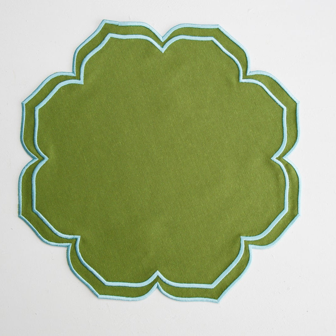 Green decorative item with a geometric pattern on a white background