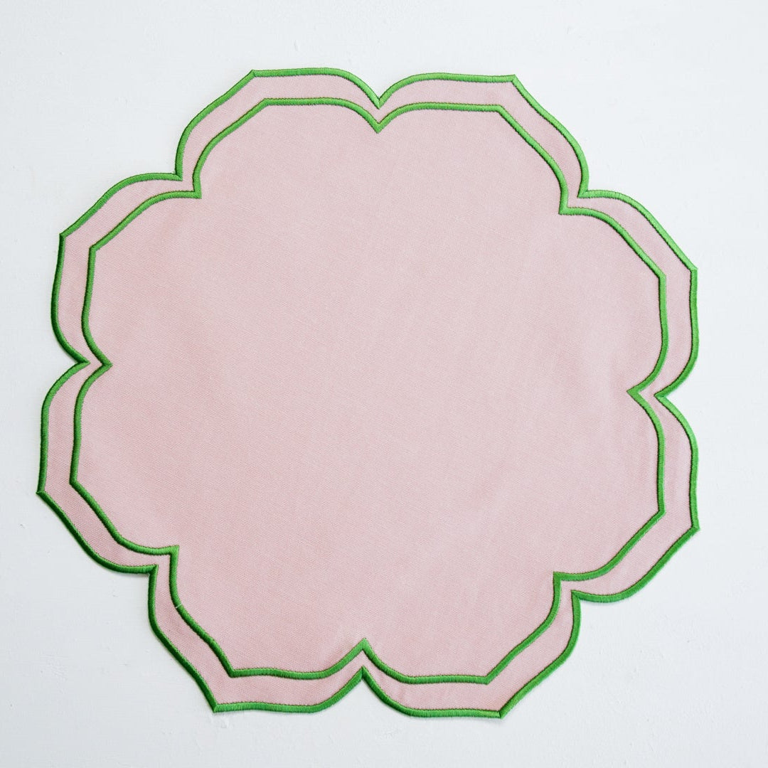 Decorative pink plate with green rim on a light gray background