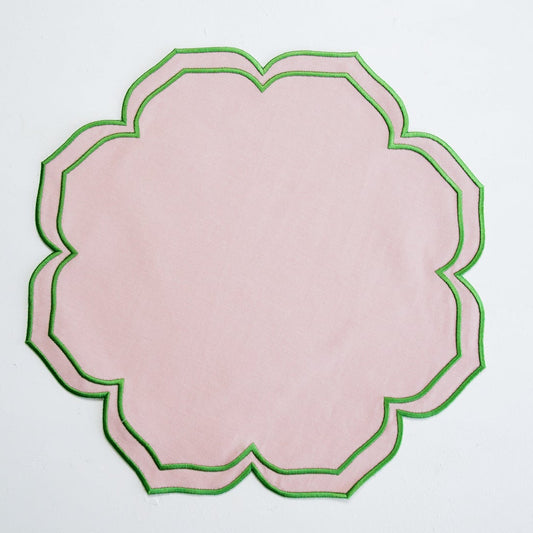 Decorative pink plate with green rim on a light gray background