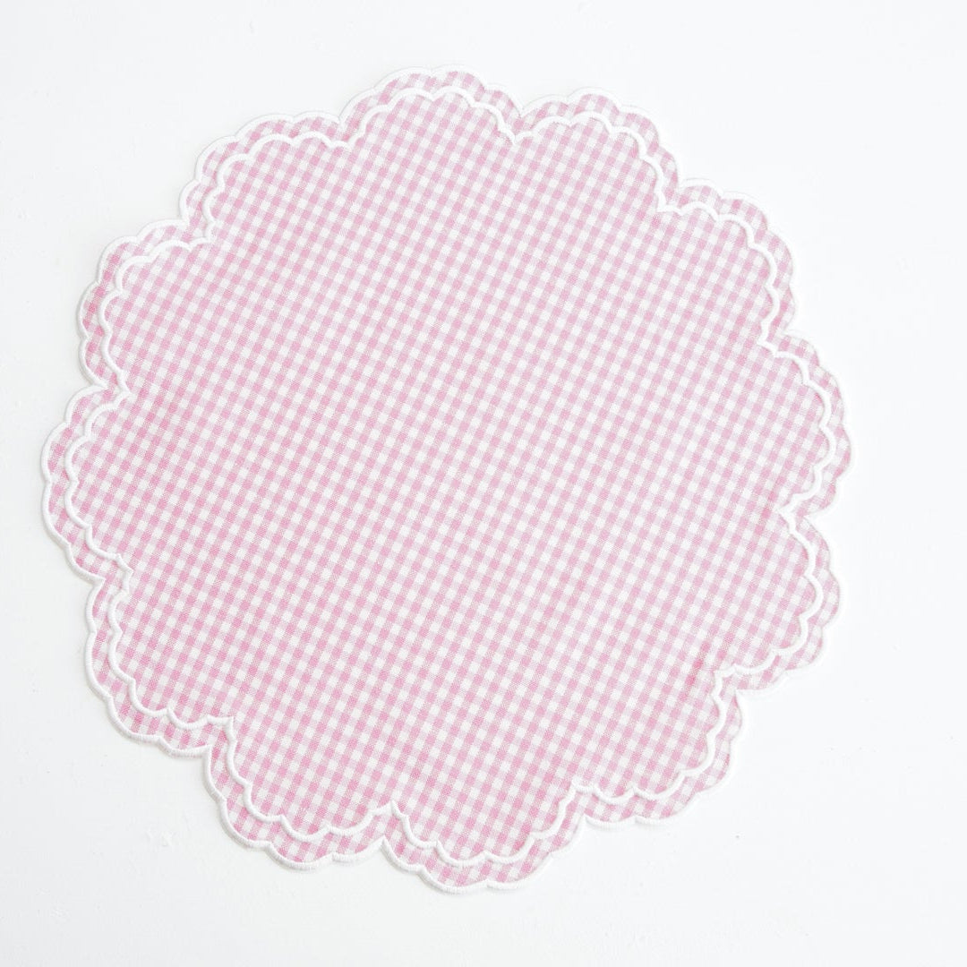 Pink checkered doily on a white background
