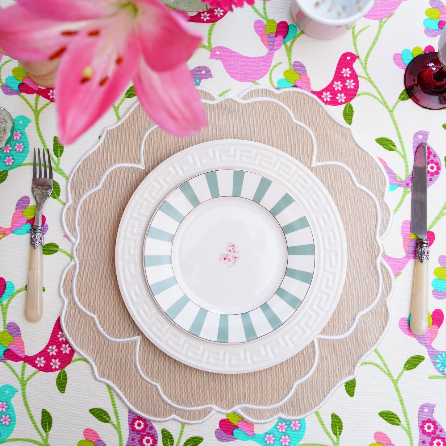 Colorful table setting with flowers and patterned placemats