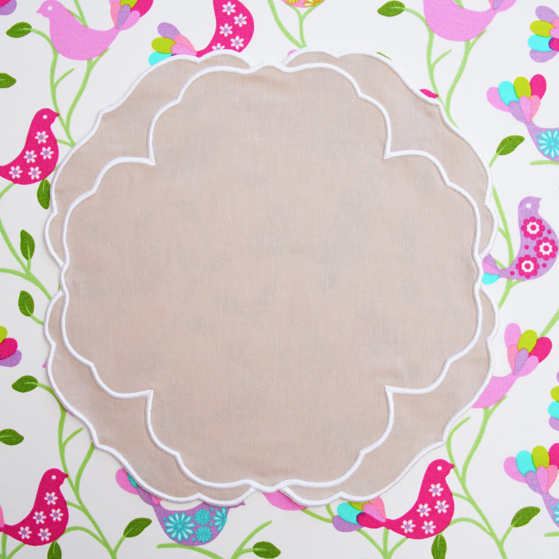 Decorative paper with colorful bird pattern and a beige oval center