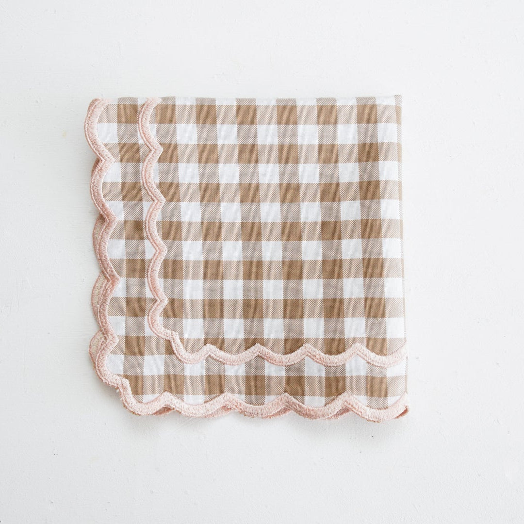 Checkered napkin with scalloped edge on a white background