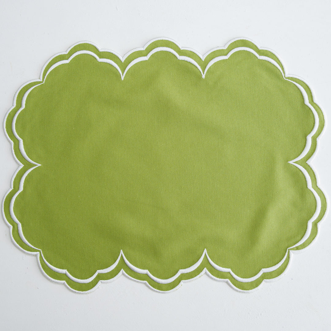 Green scalloped placemat on a white background