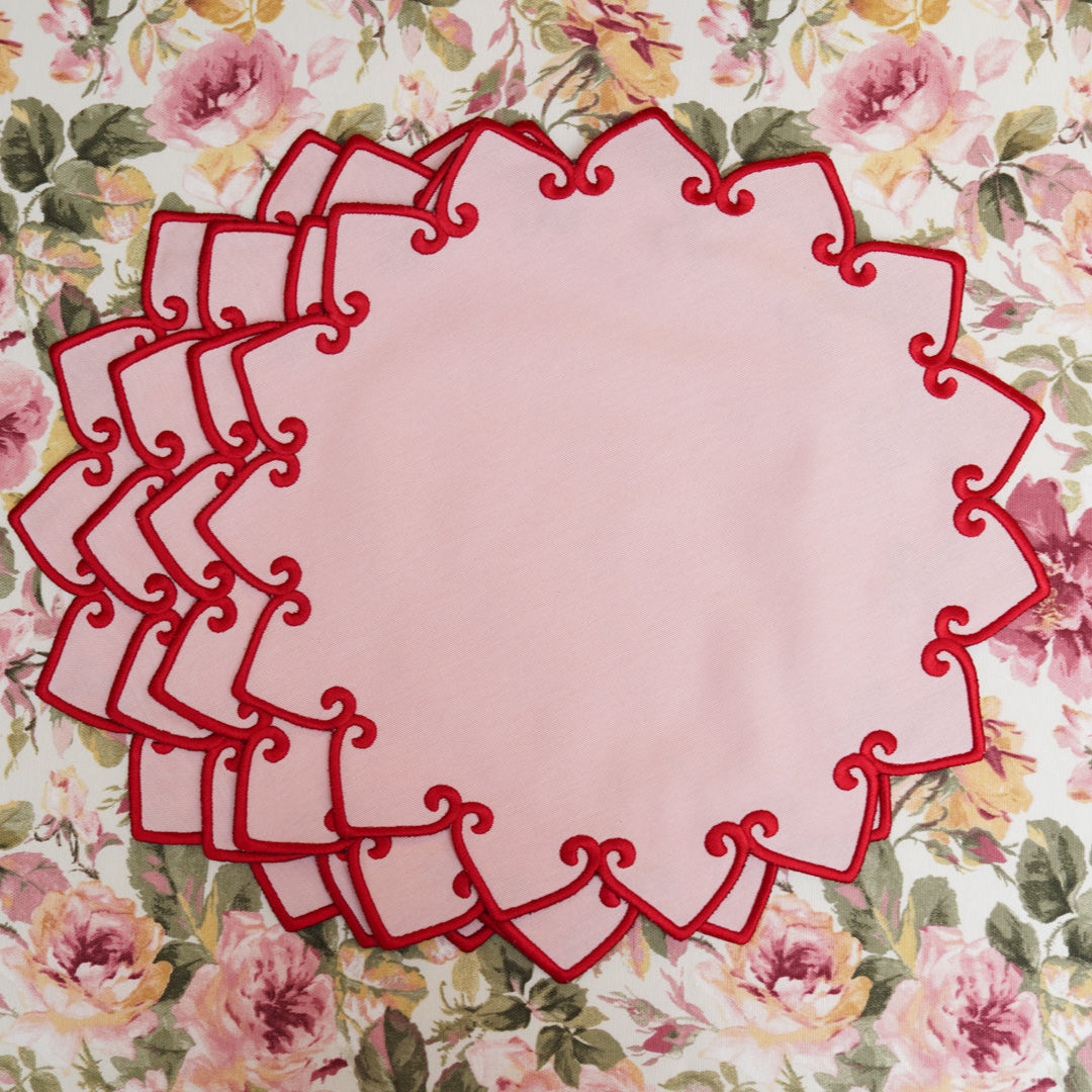 Decorative pink oval with red border on a floral background