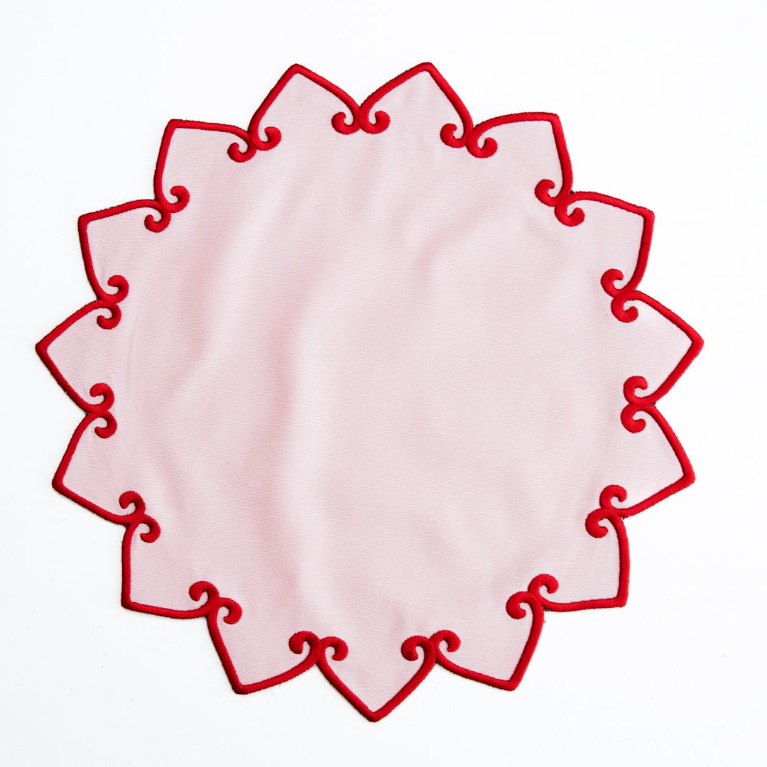 Decorative red lace doily on a white background