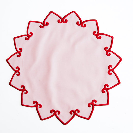 Decorative red lace doily on a white background