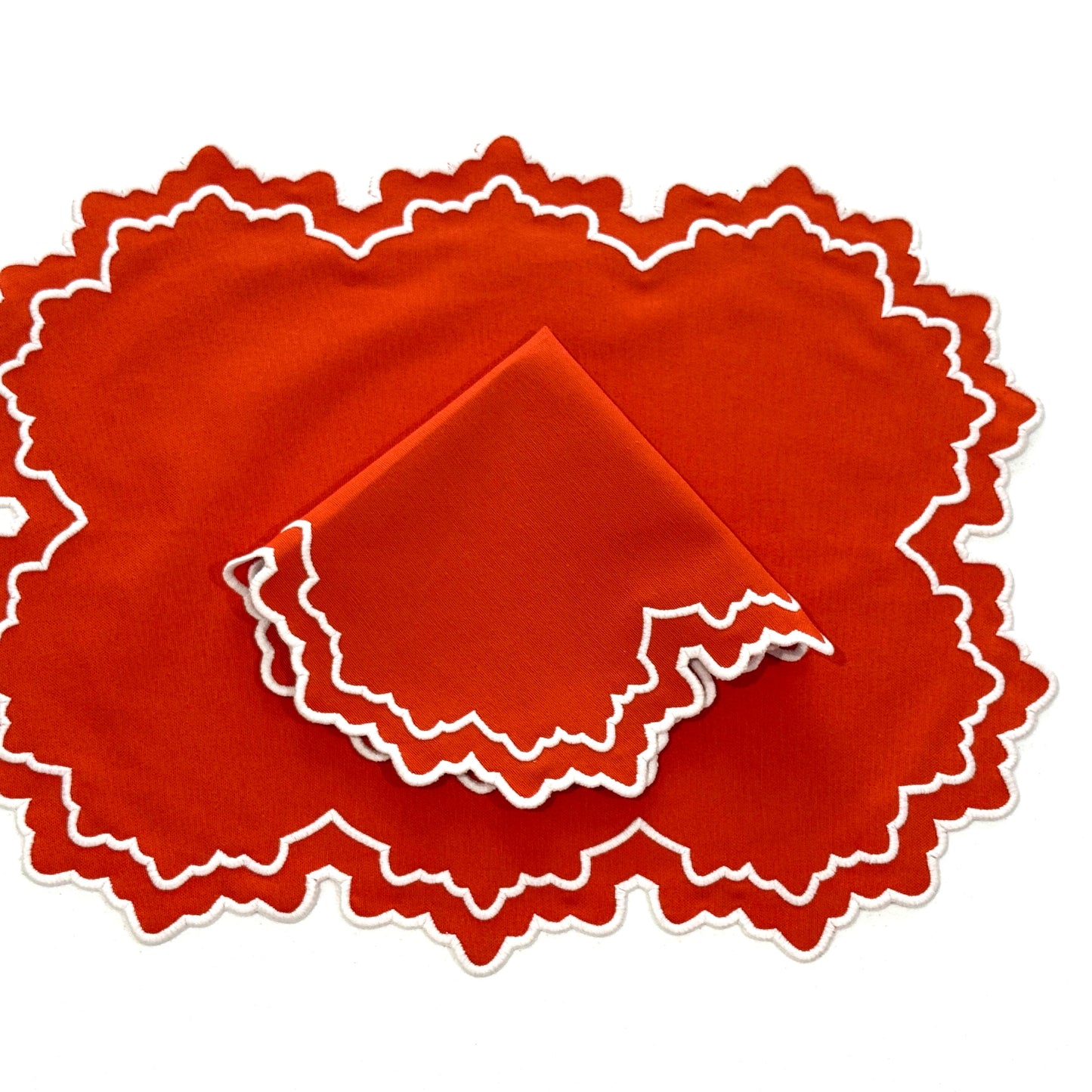 Orange fabric with white scalloped edges on a white background