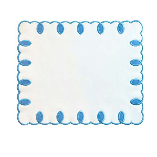 A rectangular faux leather placemat with blue embroidered detailing around the edge.