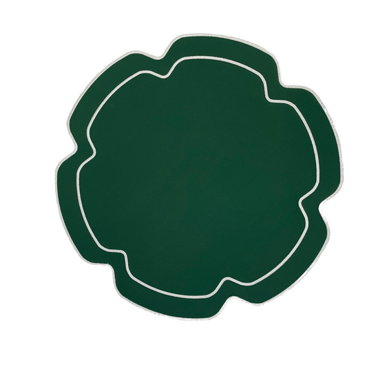 A green faux leather placemat with a flower-like shape and white embroidered details around the edge.