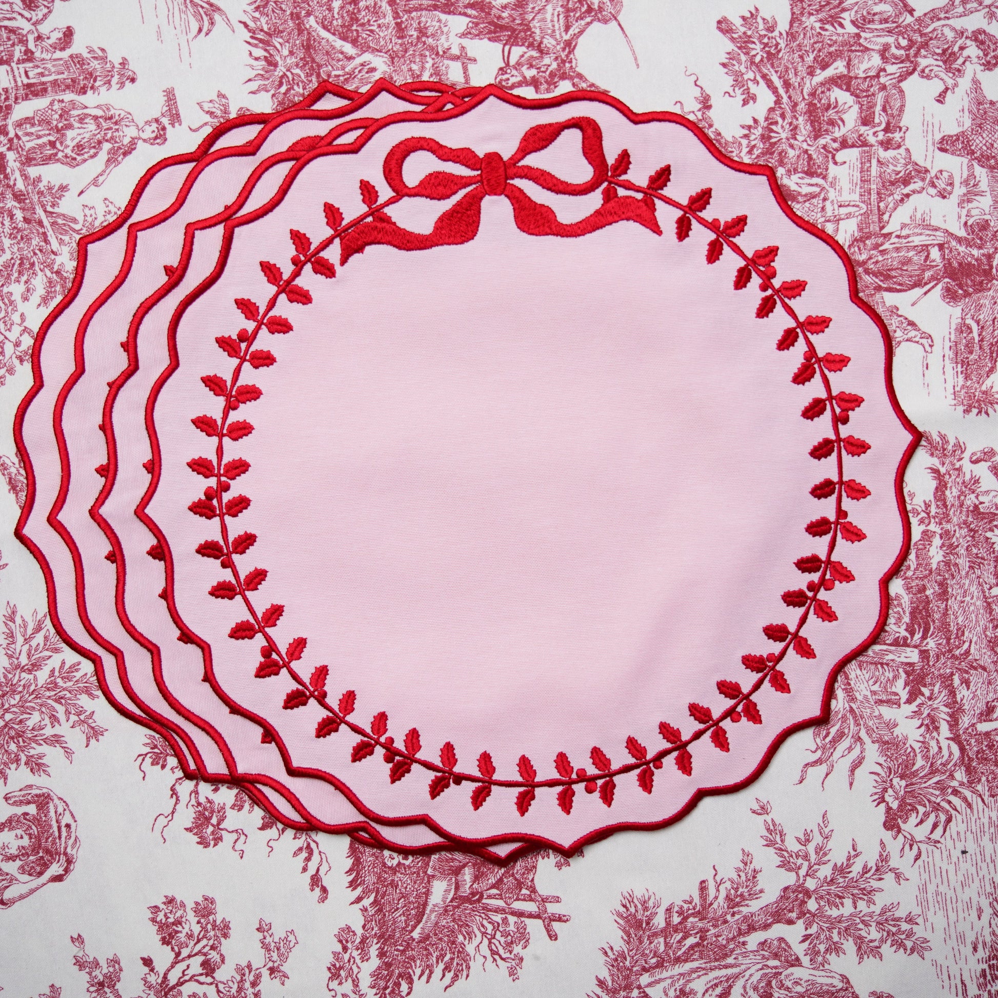 Decorative red plate with floral design on a matching patterned background