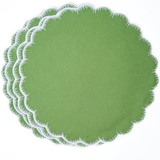 Set of green round placemats with scalloped edge on a white background