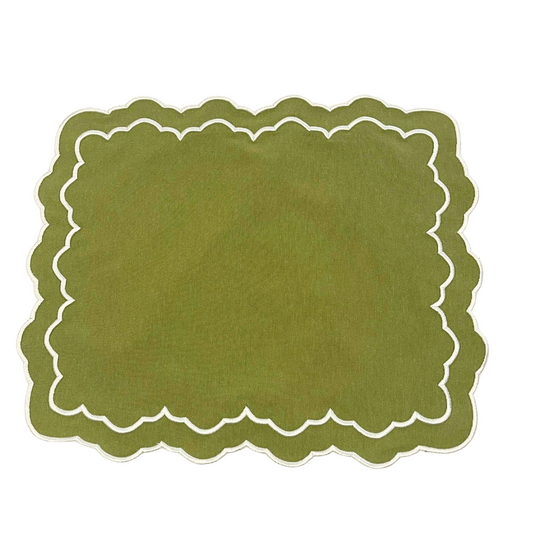 Green placemat with scalloped edge on a white background