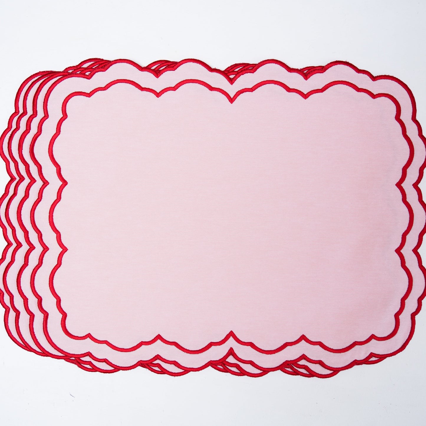 Stack of red lace doilies on a white background