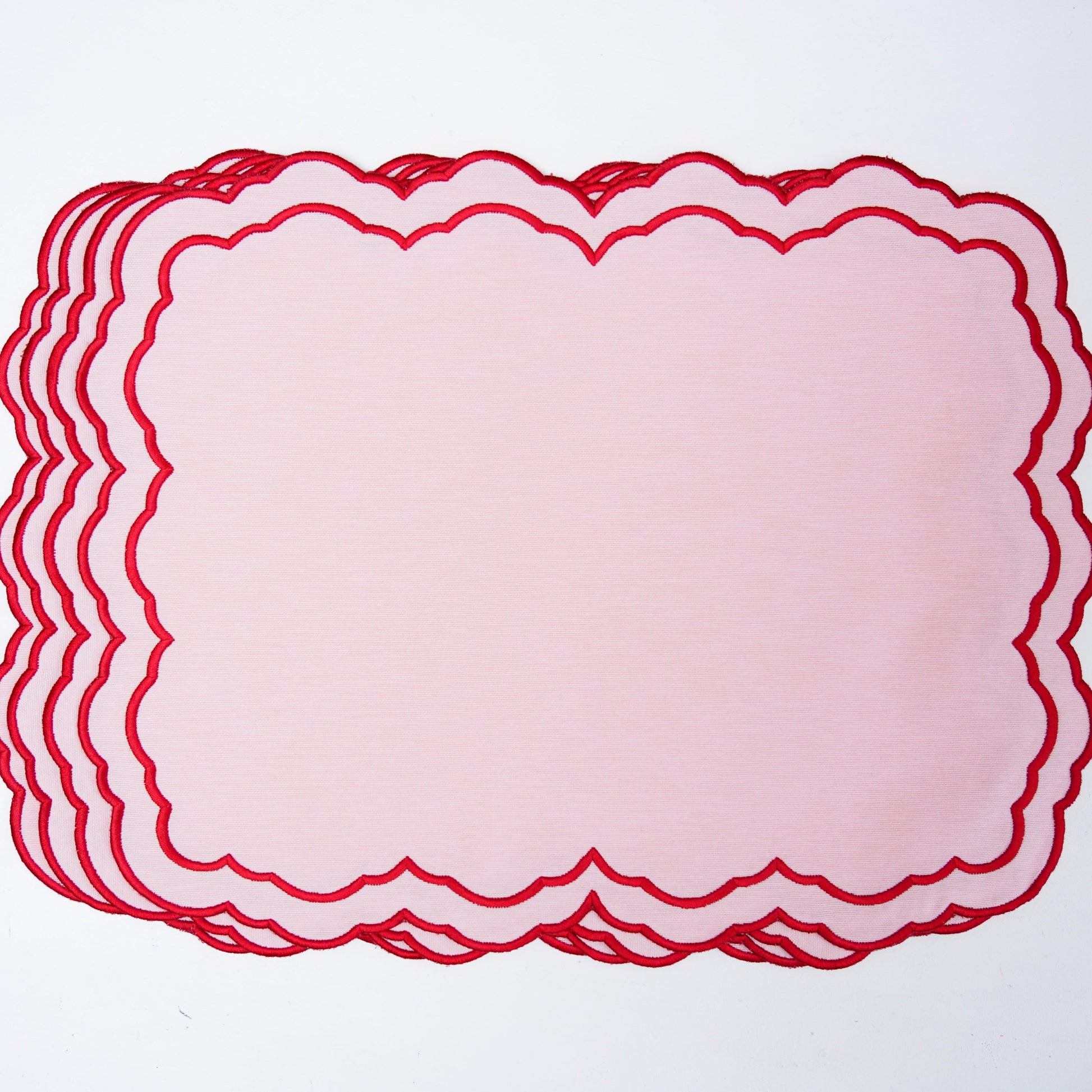 Stack of red lace doilies on a white background