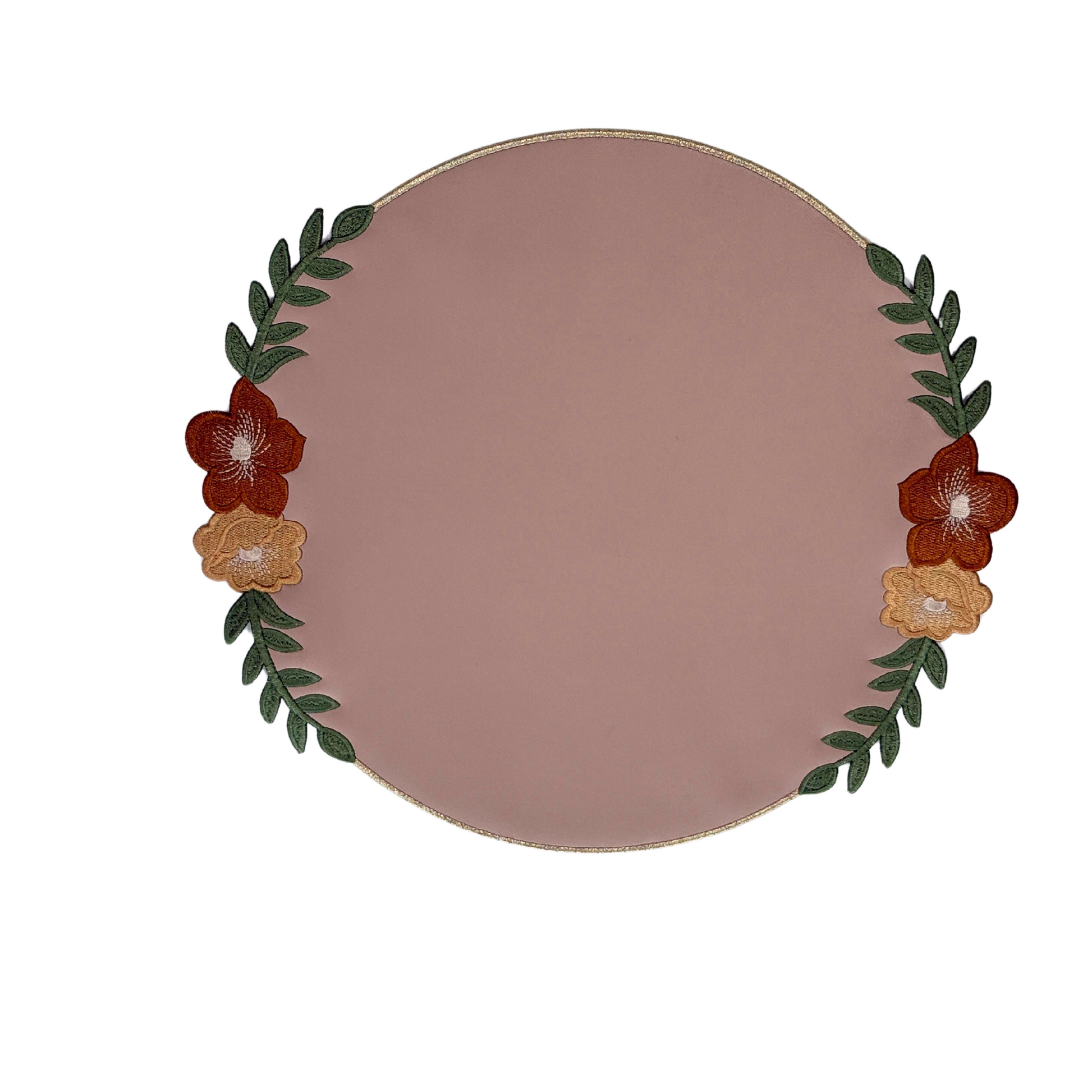 A round beige faux leather placemat with floral pattern embroidery.