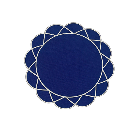 A navy blue fabric placemat with a floral pattern around the border.
