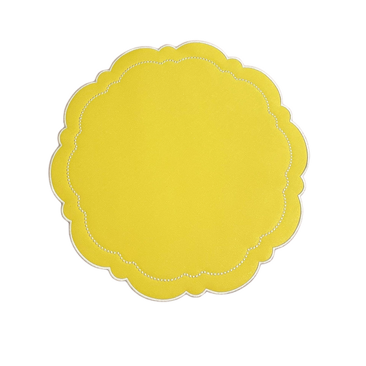 A round yellow faux leather placemat with a scalloped edge design.