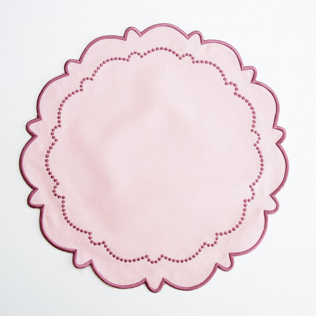 Pink doily on a white background