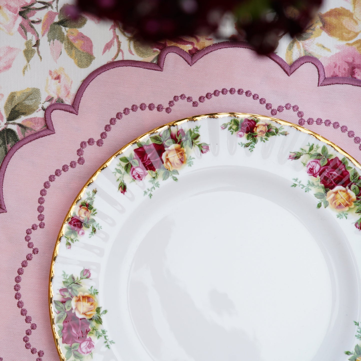 Decorative plate with floral pattern on a table setting.