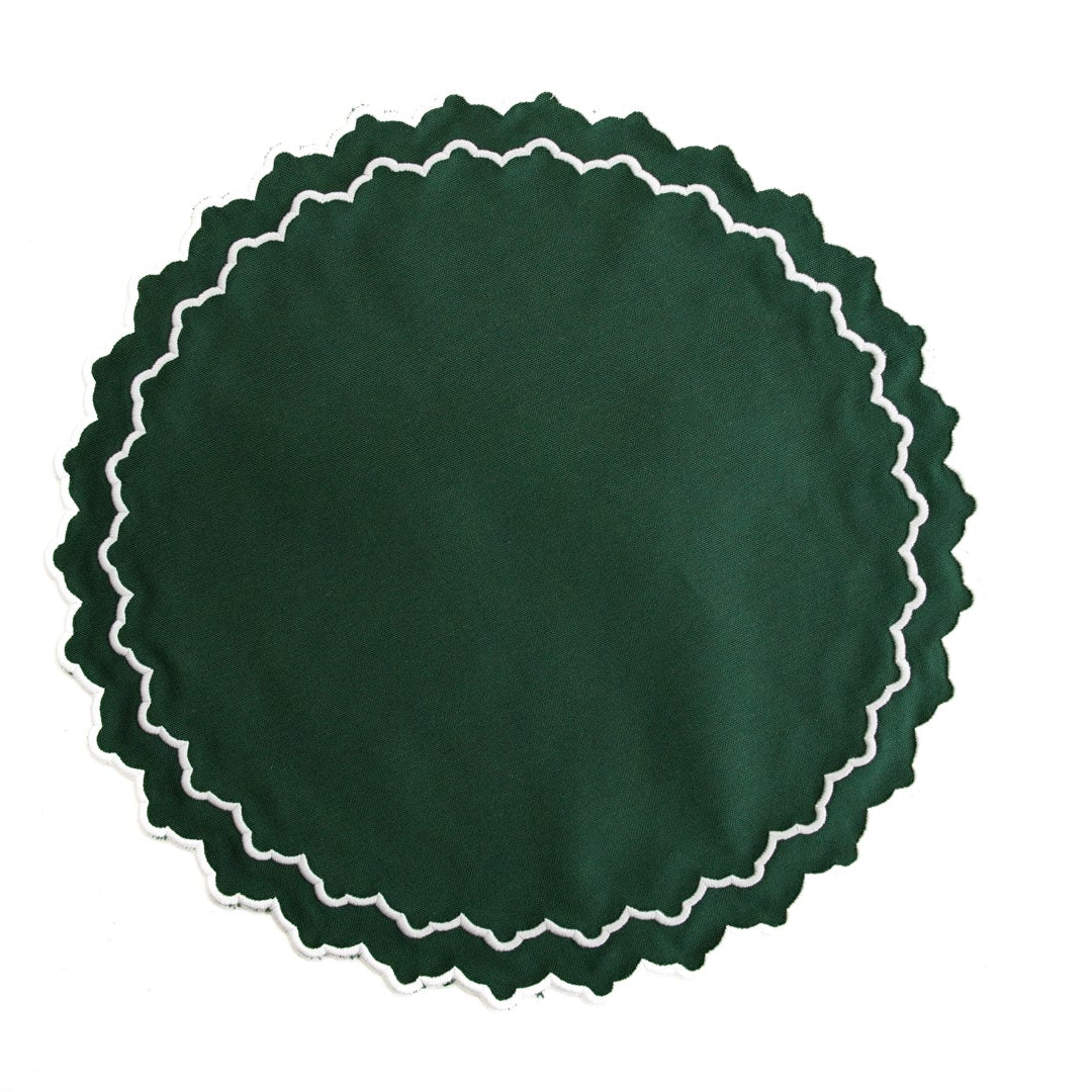 Green circular object with white scalloped edge on a white background
